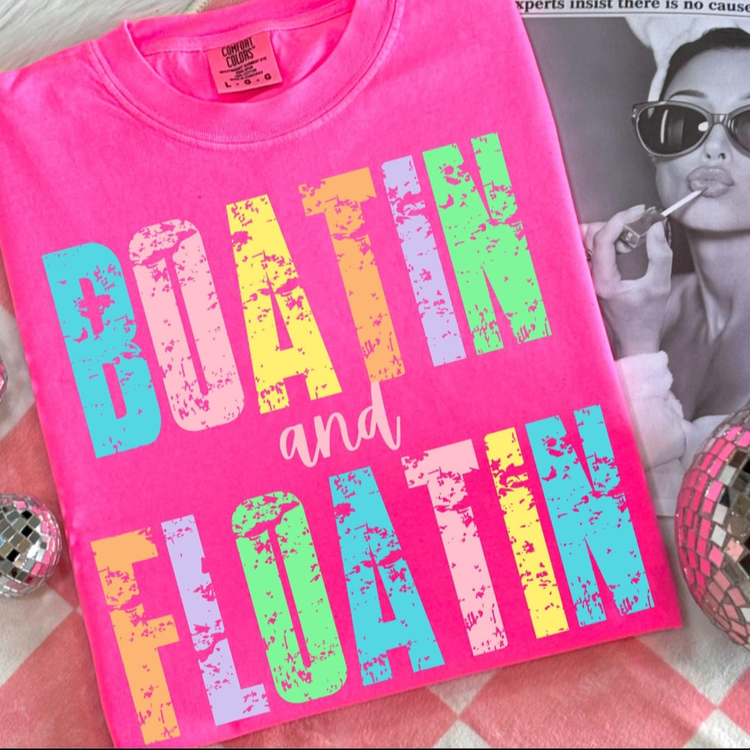 Neon Pink Comfort Colors tee with distressed multicolor Boatin and Floatin graphic