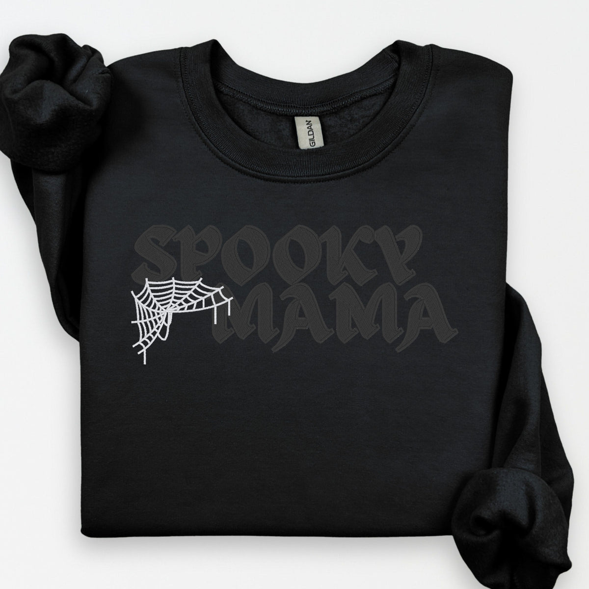 Black on black Spooky Mama embroidered sweatshirt with tonal gothic lettering and contrasting white spiderweb