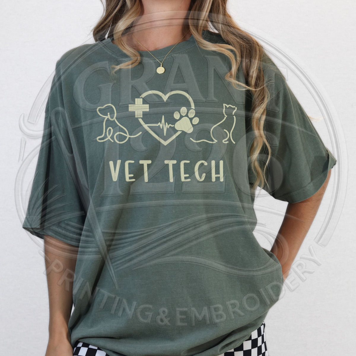 Woman wearing embroidered veterinary technician shirt with dog cat design