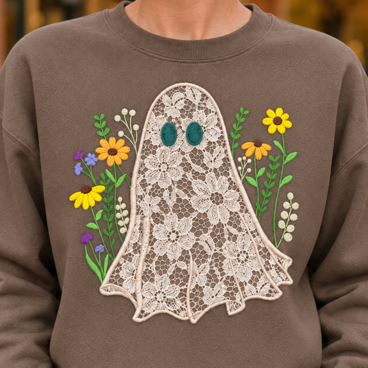 Detailed view of floral lace ghost appliqué and dimensional wildflower stitching on Brown Savanna