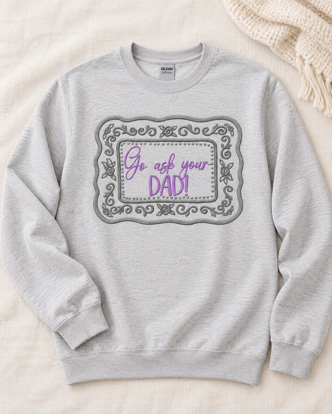Ash embroidered Go Ask Your Dad sweatshirt styled on neutral linen