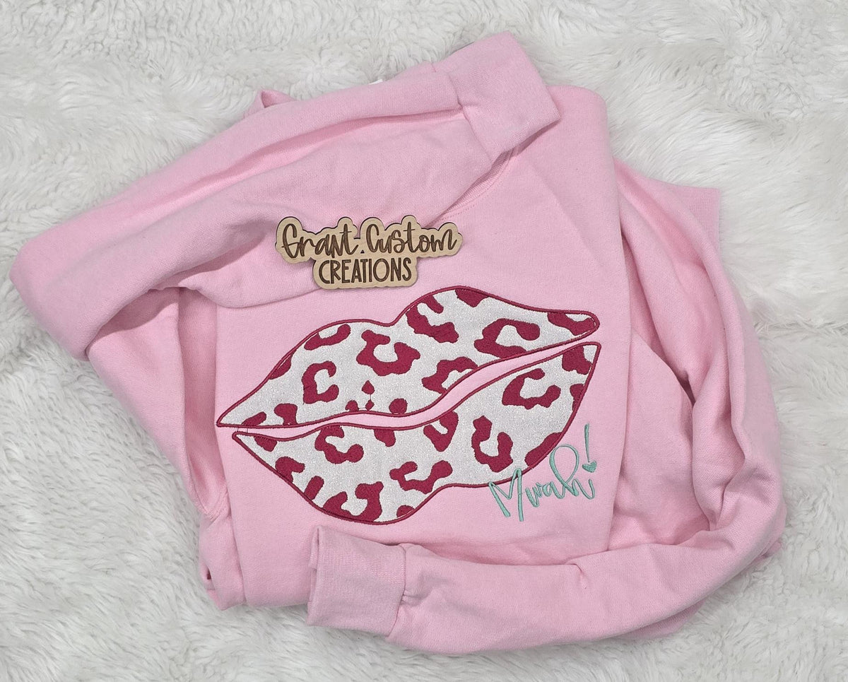 Close-up of embroidered Valentine design on crewneck sweatshirt