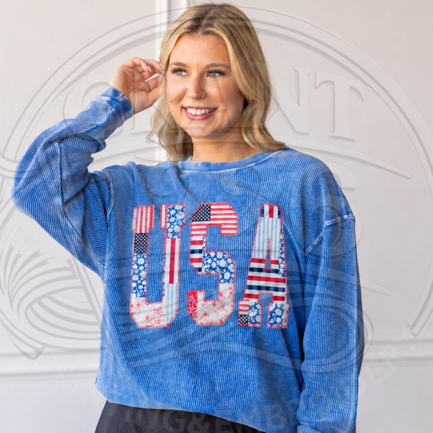 Lifestyle photo of blue USA applique sweatshirt styled as a patriotic outfit for Fourth of July and summer holidays.