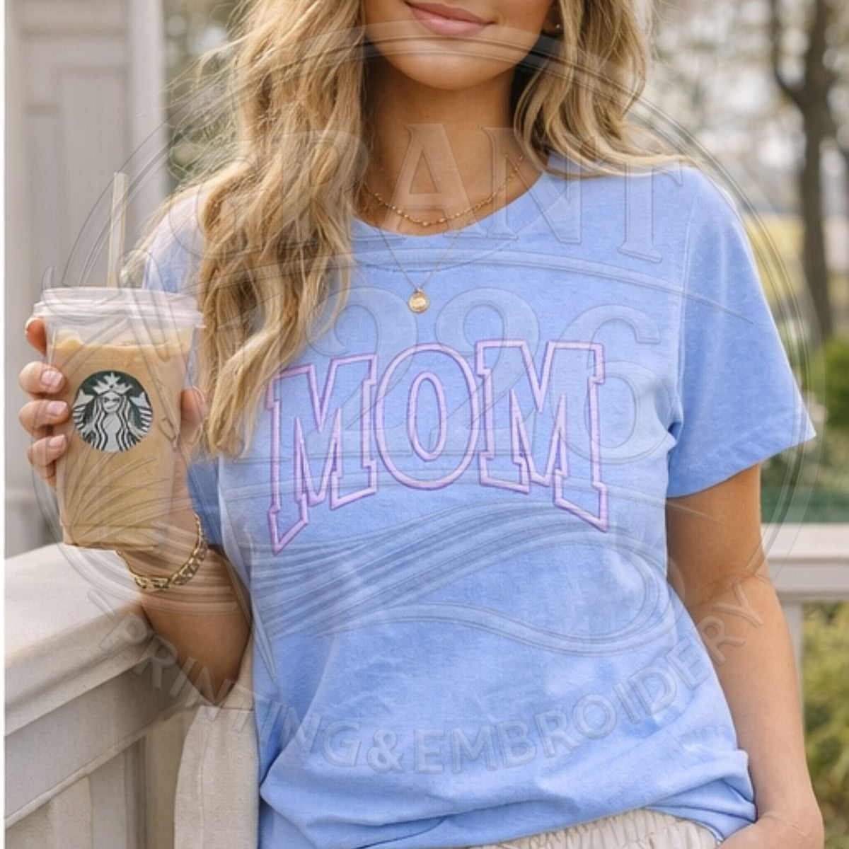 Woman wearing blue Comfort Colors mom shirt holding iced coffee