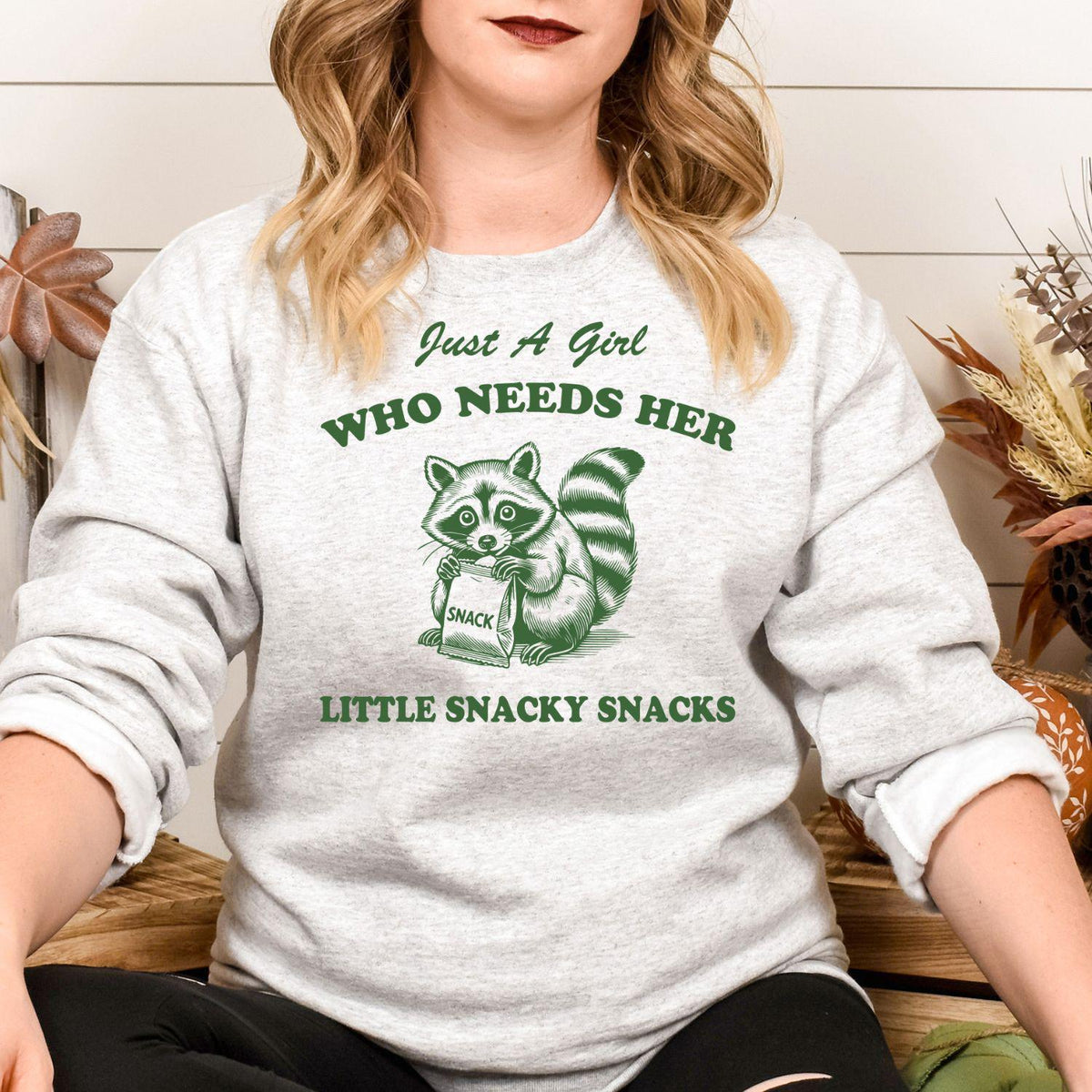 Sport gray funny snacky raccoon crewneck modeled while seated