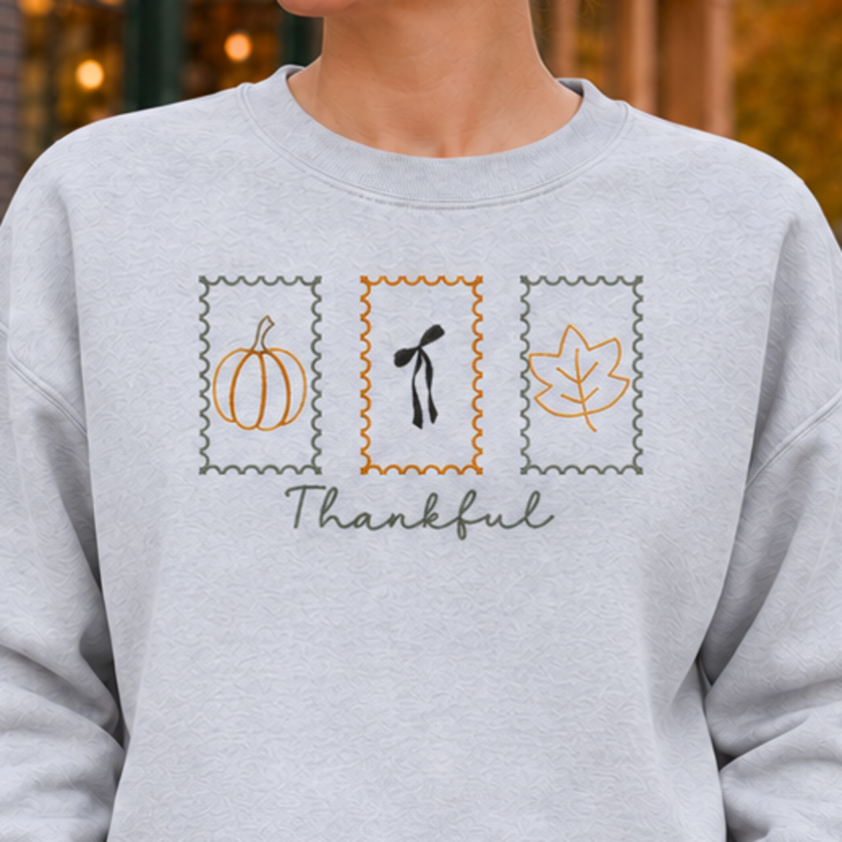 Ash sweatshirt chest detail with Thankful Stamps embroidery