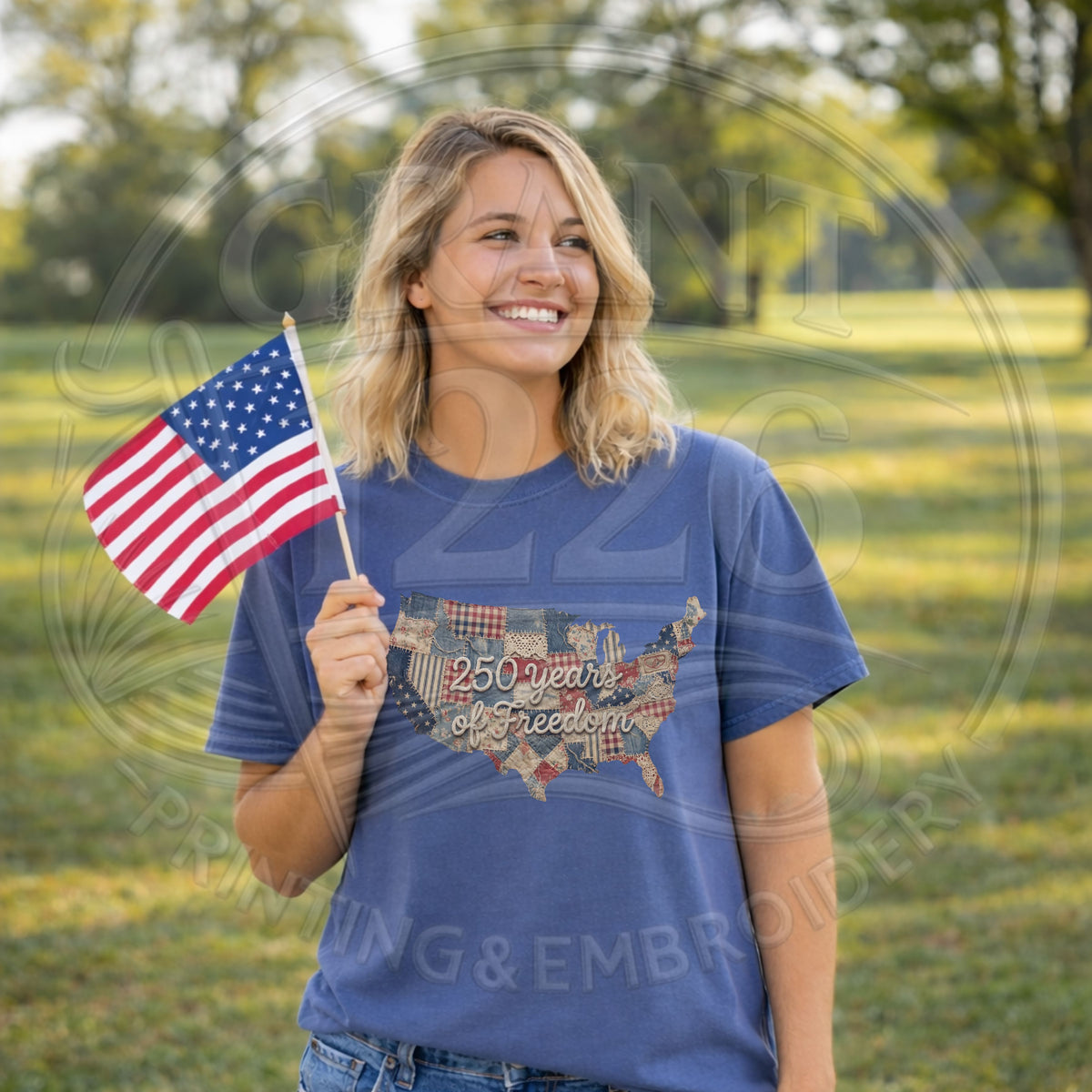 Blue America 250 graphic tee modeled outdoors with an American flag