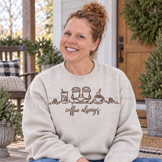 Coffee Always embroidered Gildan Softstyle sweatshirt in Sand modeled on a farmhouse porch