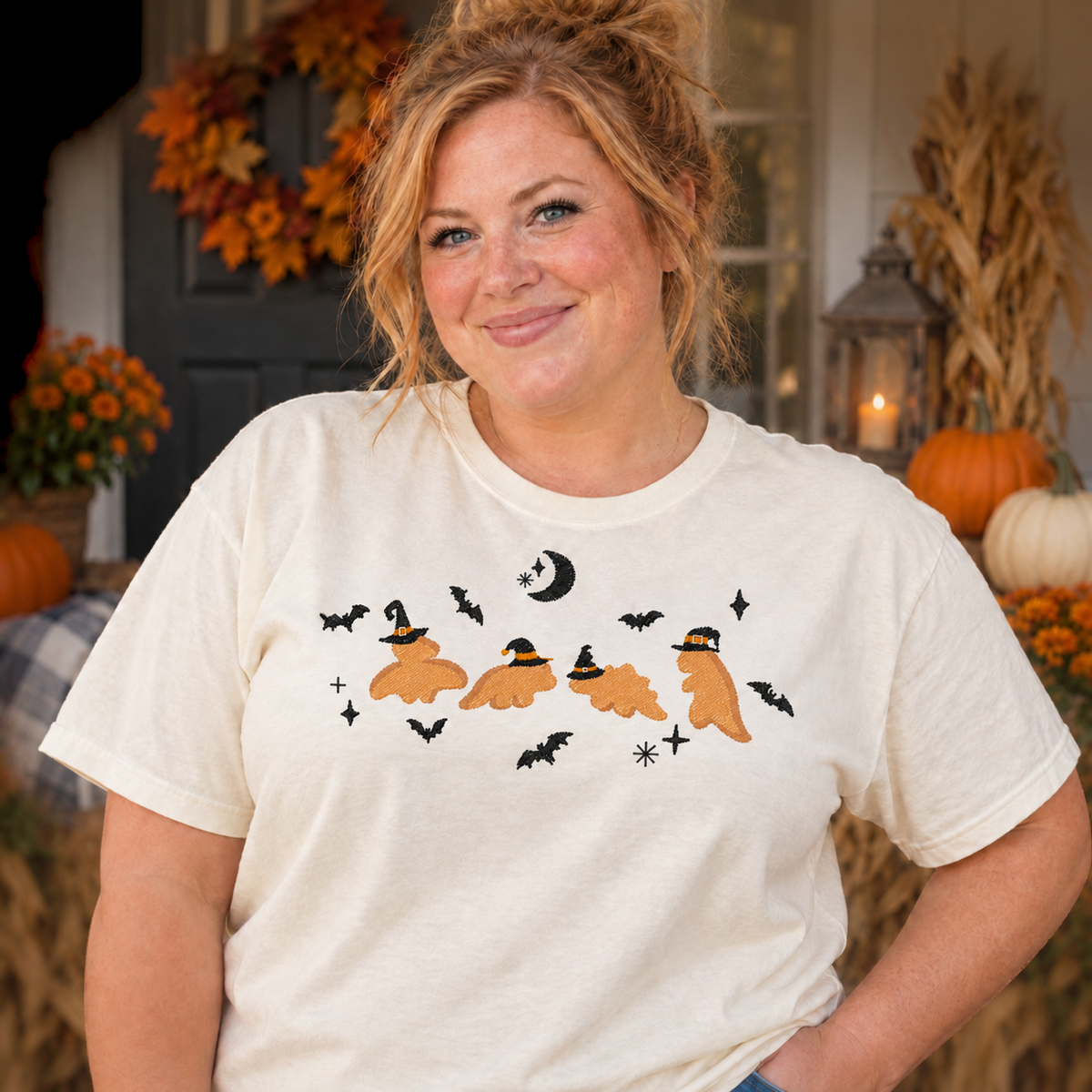 Woman wearing an ivory Dinosaur Witches embroidered Halloween T-shirt