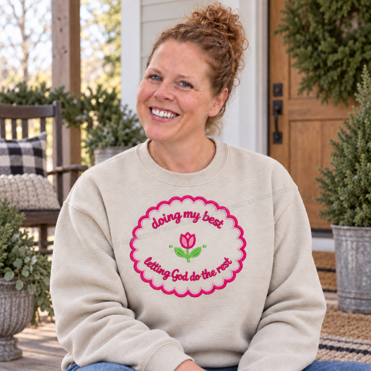 Doing My Best letting God do the rest embroidered sand sweatshirt modeled on a porch
