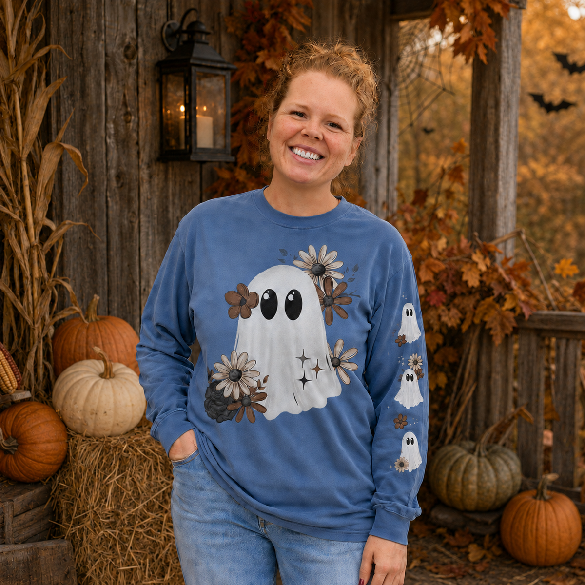 Woman wearing a Blue Jean Comfort Colors 6014 floral ghost Halloween long-sleeve shirt with coordinating sleeve print
