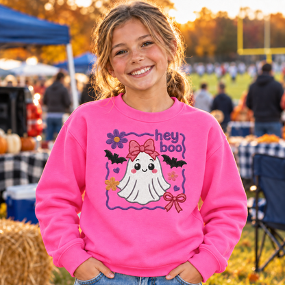 Youth girl wearing a Safety Pink Hey Boo embroidered Halloween sweatshirt