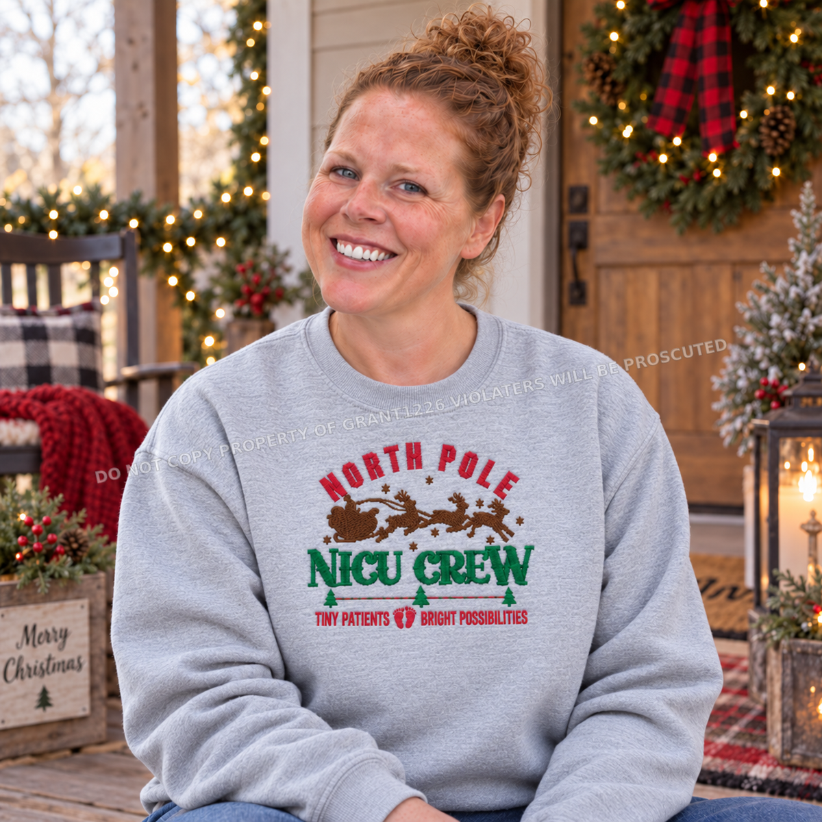 North Pole NICU Crew embroidered sweatshirt in Ash modeled on a rustic Christmas porch