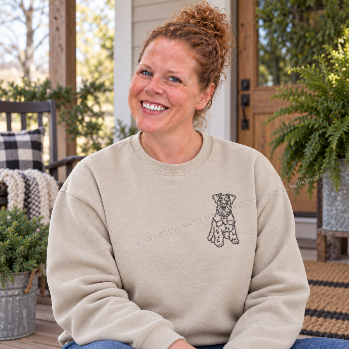 Schnauzer embroidered sand Gildan Softstyle sweatshirt modeled on a farmhouse porch