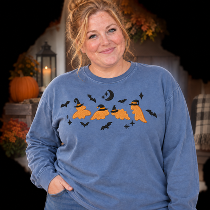 Woman wearing a Blue Jean long-sleeve Dinosaur Witches embroidered Halloween shirt