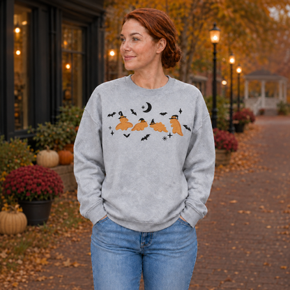 Woman wearing a Sport Grey Dinosaur Witches embroidered Halloween sweatshirt