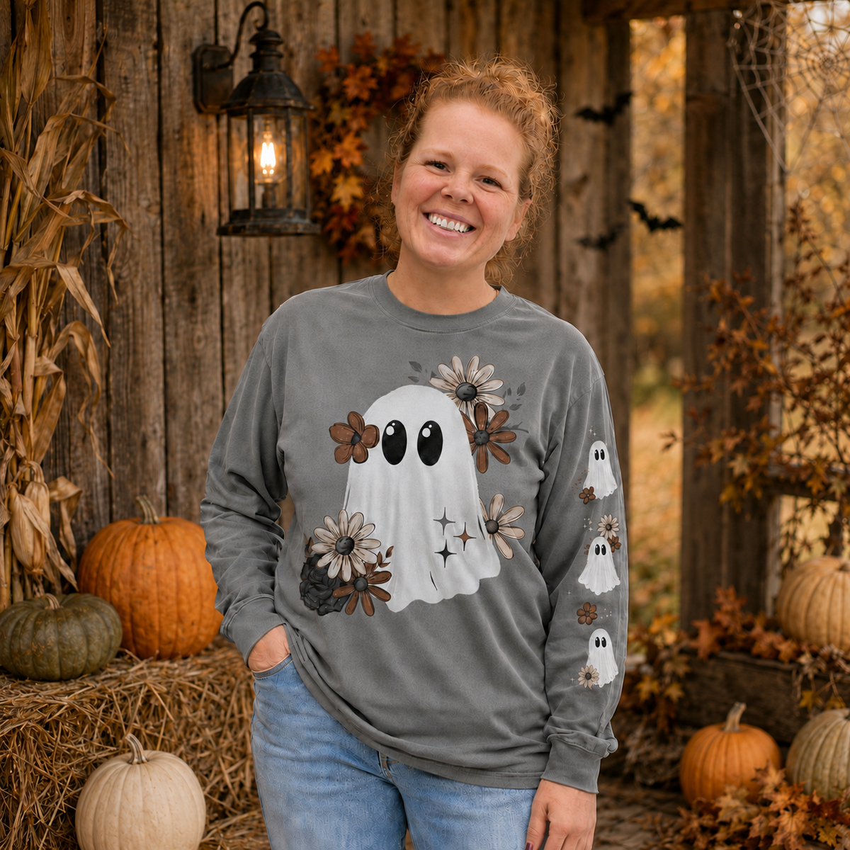Woman wearing a Grey Comfort Colors 6014 floral ghost Halloween long-sleeve shirt with floral ghost sleeve print