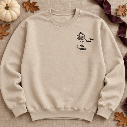 Sand crewneck sweatshirt flat lay with black jack-o-lantern, two bats, and witch hat embroidery.