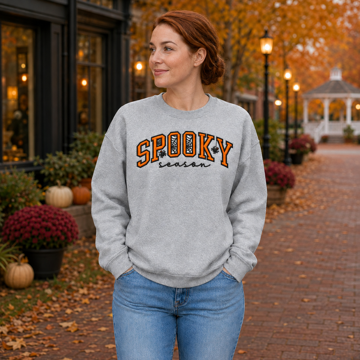 Adult woman wearing a Sport Grey Spooky Season embroidered Halloween sweatshirt