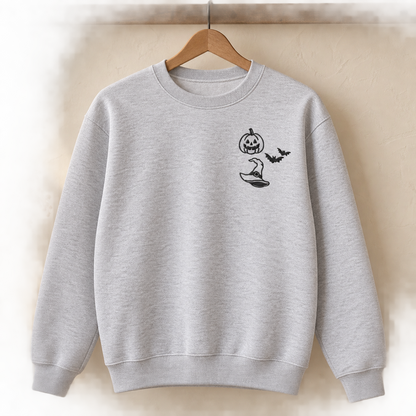 Ash grey Halloween embroidered sweatshirt hanging on a wooden hanger with a left-chest design.