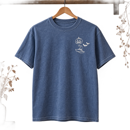 Blue Jean garment-dyed T-shirt hanging with white Halloween embroidery on the left chest.