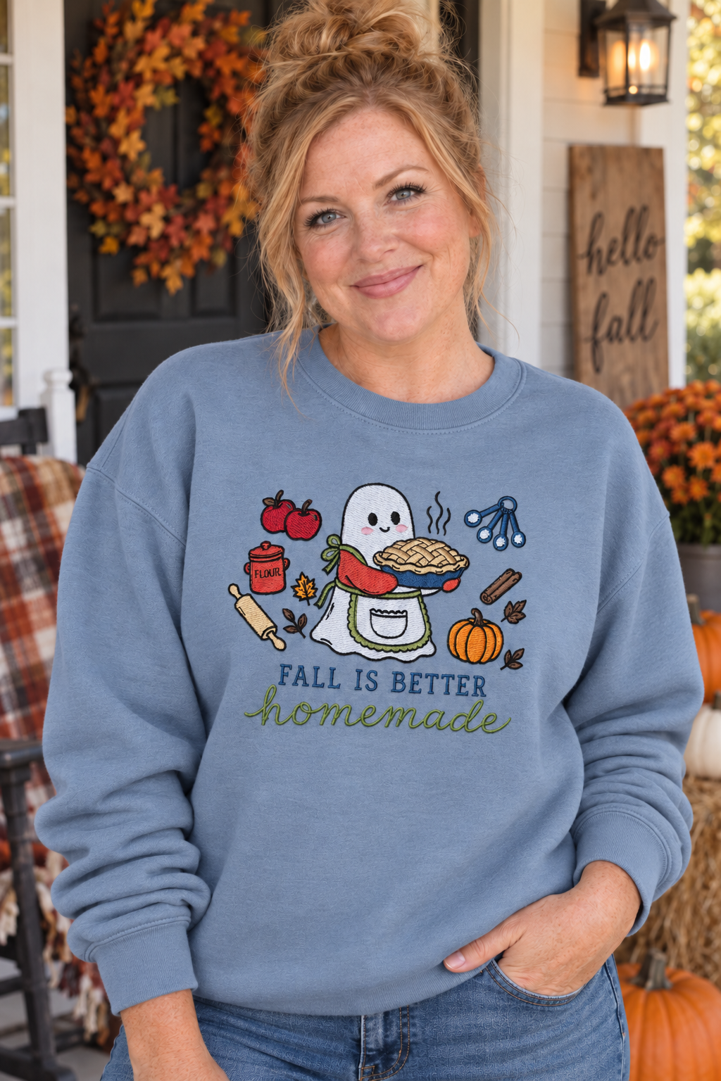 Woman wearing a Stone Blue Fall Is Better Homemade embroidered ghost baker sweatshirt