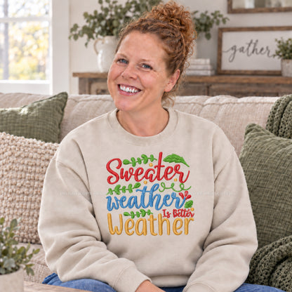 Sand colorful Sweater Weather embroidered fall crewneck modeled in a cozy living room