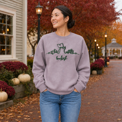 Bookish reader machine embroidery centered on a Paragon Gildan Softstyle sweatshirt, approximately 10 inches wide