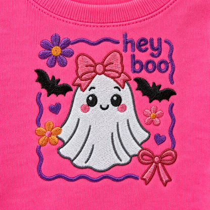 Close-up of Hey Boo ghost machine embroidery with purple pink orange and black thread