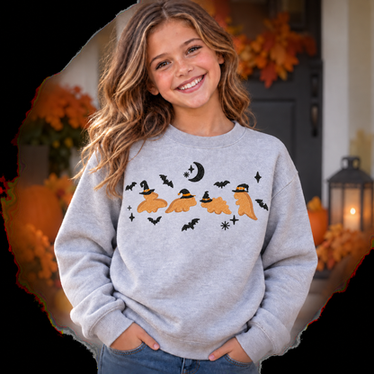 Girl wearing a Sport Grey youth Dinosaur Witches embroidered Halloween sweatshirt