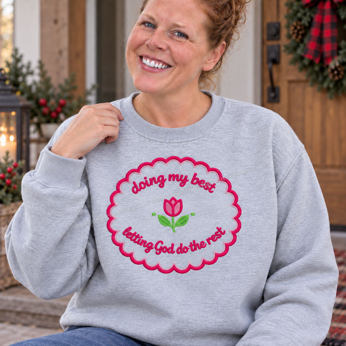 Close up of pink floral Doing My Best Christian embroidery on ash sweatshirt