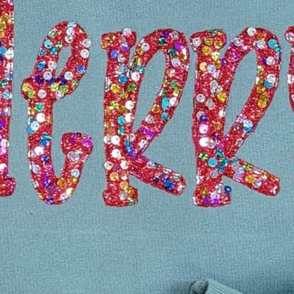 Macro detail of colorful sequins and red satin stitch embroidery on MERRY applique