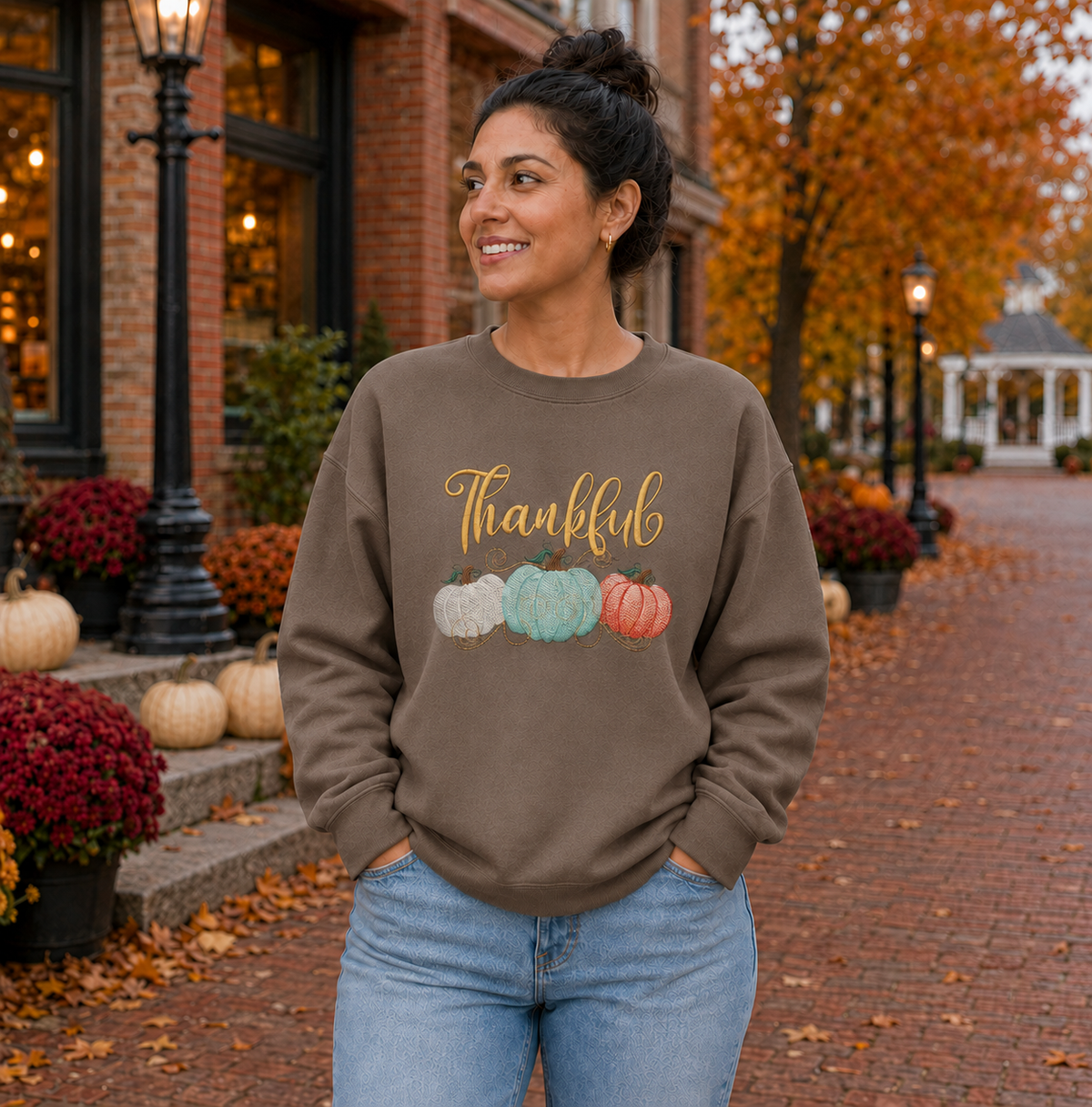 Thankful pumpkin embroidered Brown Savanna Gildan Softstyle sweatshirt in an autumn town square