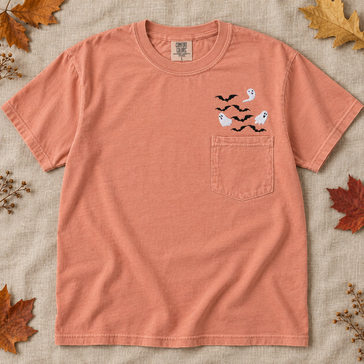 Terracotta Comfort Colors ghost and bats embroidered pocket T-shirt in an autumn flat lay