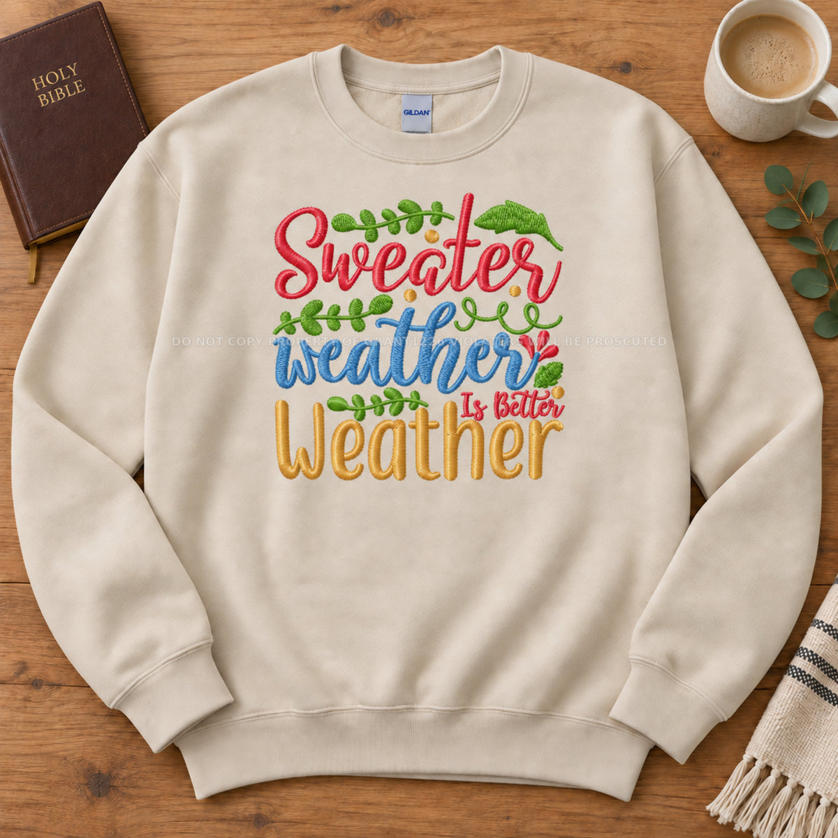 Sand Sweater Weather embroidered Gildan Softstyle sweatshirt arranged completely flat