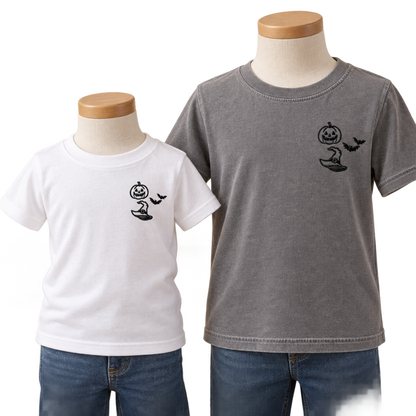 White toddler and Grey youth T-shirts with matching black Halloween left-chest embroidery.