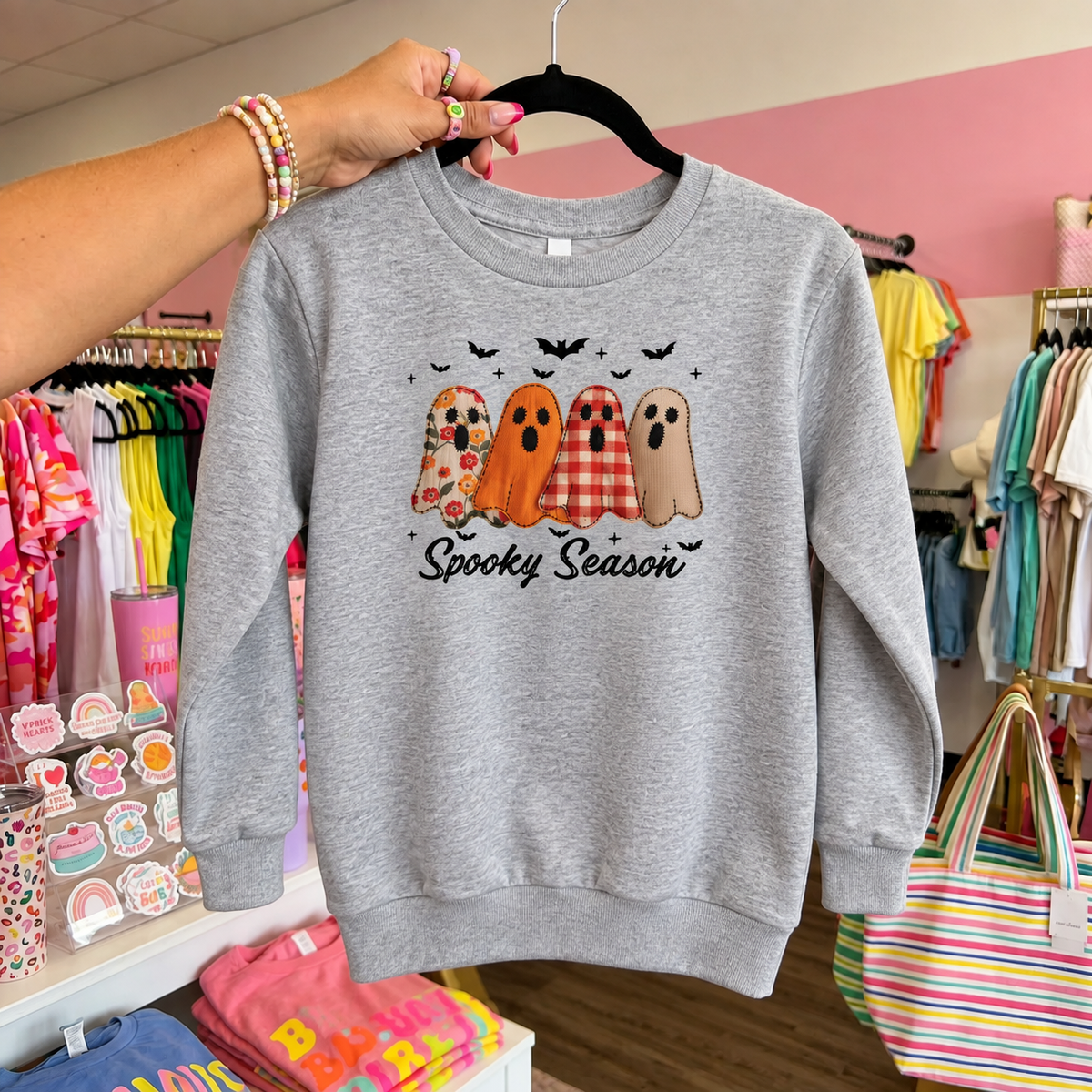 Heather LAT youth crewneck sweatshirt on a hanger with four patterned ghosts and Spooky Season lettering.