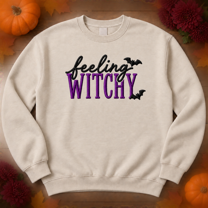 Sand crewneck sweatshirt flatlay with purple Feeling Witchy embroidery and bats