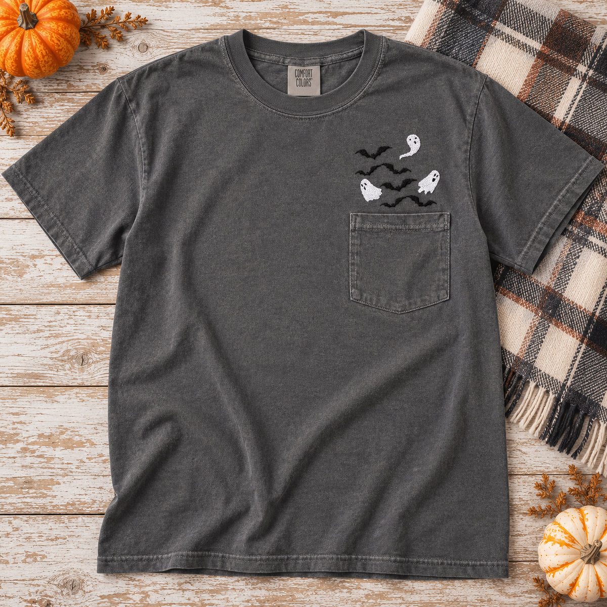 Pepper Comfort Colors pocket T-shirt with white ghost and black bat embroidery in a fall flat lay