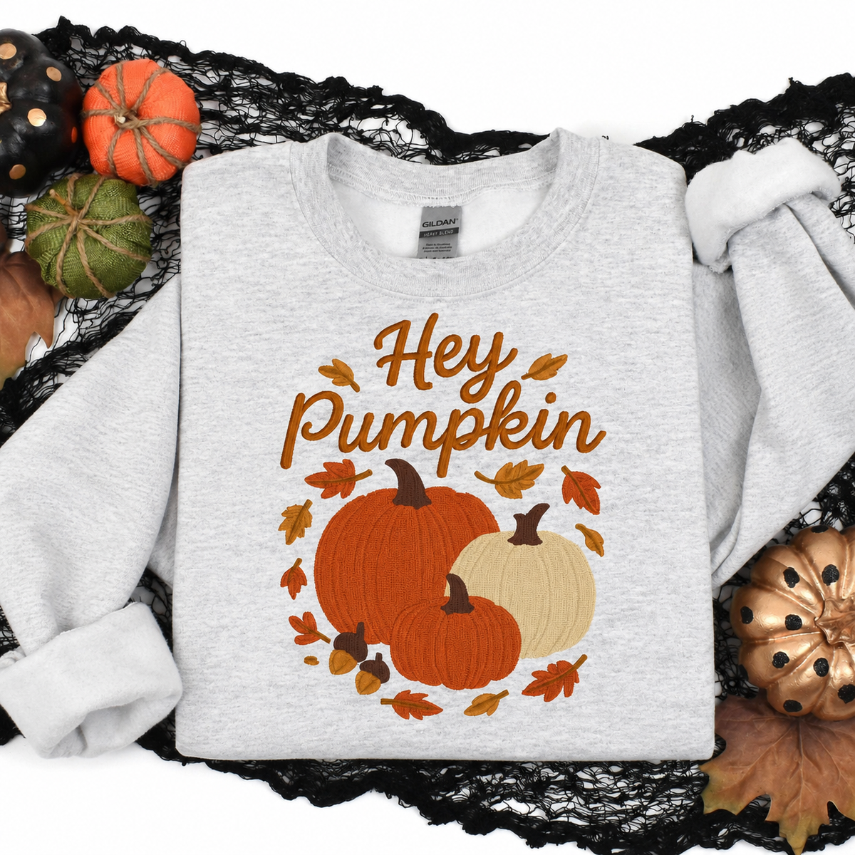 Ash Hey Pumpkin embroidered sweatshirt displayed with festive fall and Halloween accents