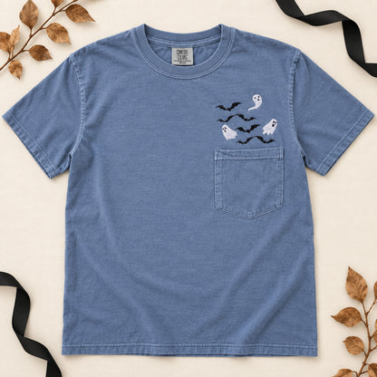 Blue Jean Comfort Colors ghost and bats embroidered pocket T-shirt arranged in a clean flat lay