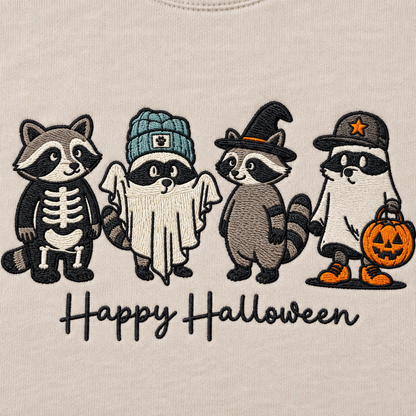 Close-up of machine embroidered Halloween raccoons with visible thread detail