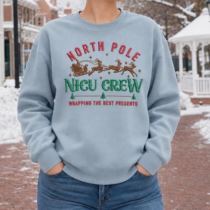 Close view of North Pole NICU Crew Christmas embroidery on a Stone Blue sweatshirt