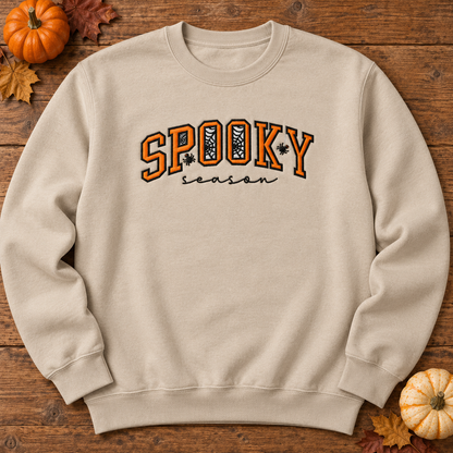 Sand Spooky Season embroidered sweatshirt flat lay with pumpkins and fall leaves