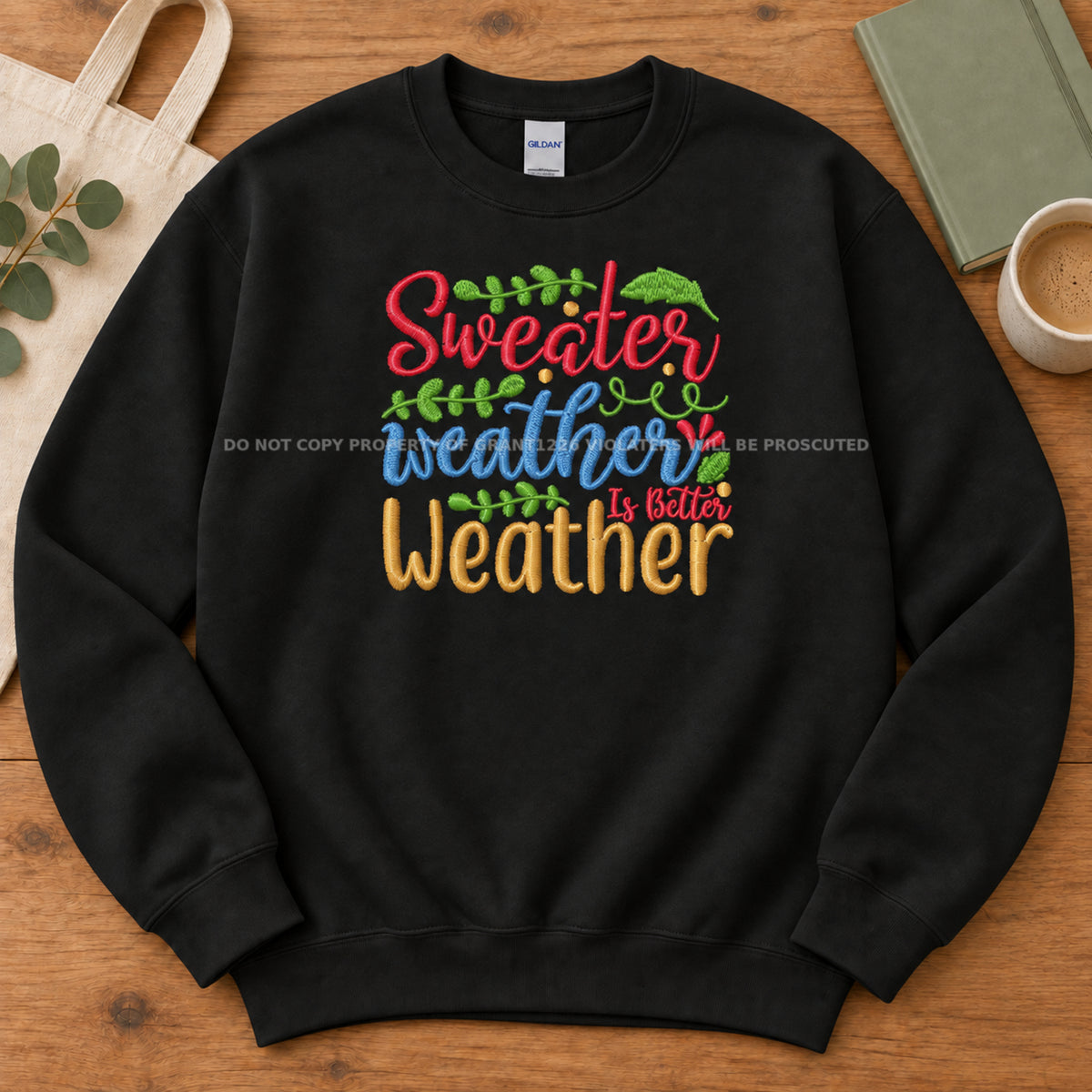 Black Sweater Weather embroidered Gildan Softstyle sweatshirt arranged completely flat