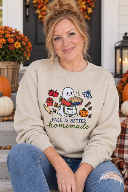 Woman seated on a fall porch wearing a Sand Fall Is Better Homemade embroidered ghost baker sweatshirt
