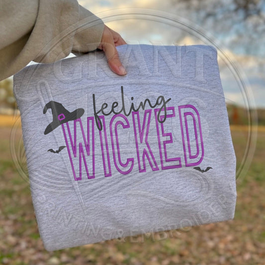 Close-up of raised puff embroidery on Feeling Wicked Halloween sweatshirt