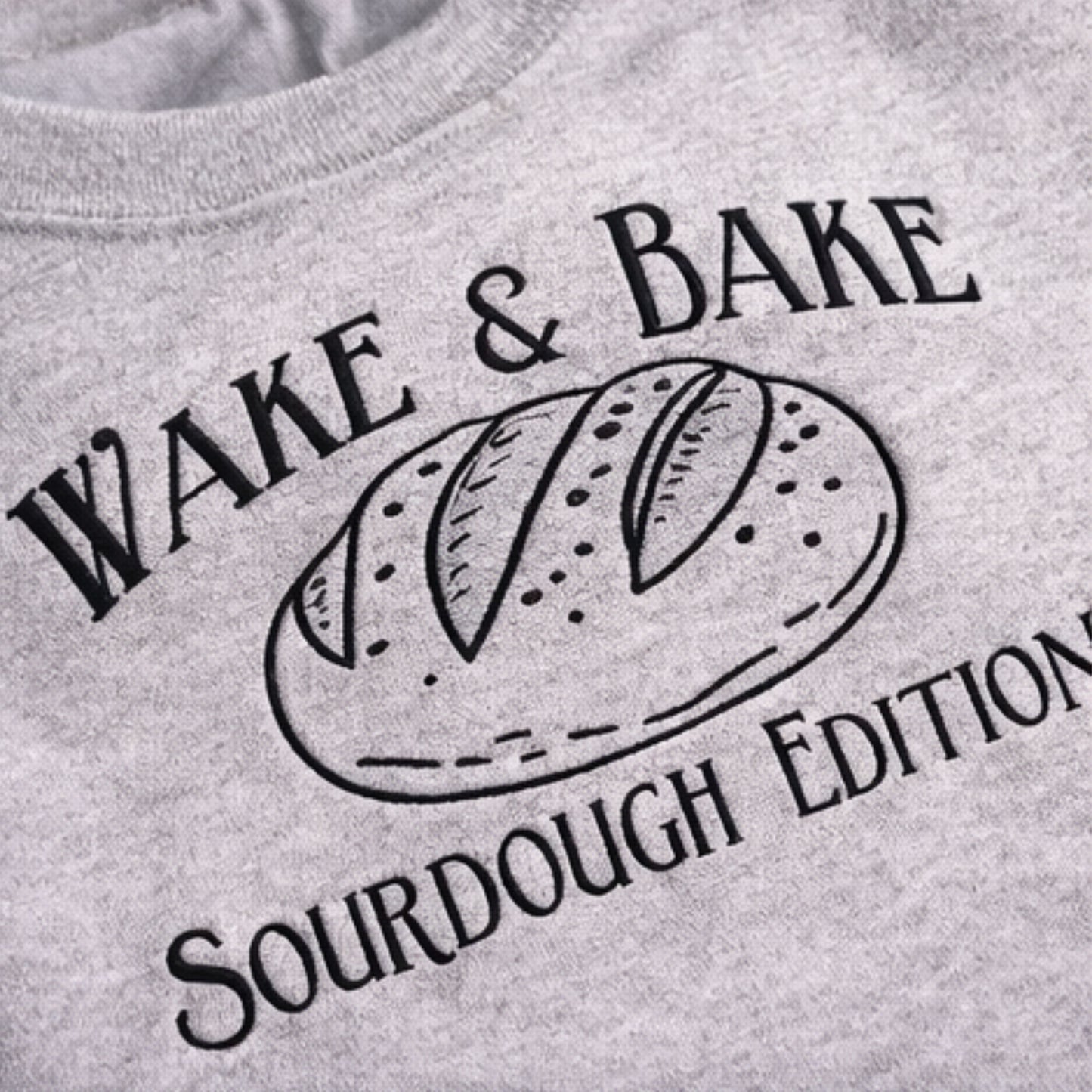 Gray sweatshirt with 'Wake & Bake Sourdough Edition' text and bread graphic.