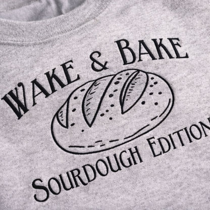 Gray sweatshirt with 'Wake & Bake Sourdough Edition' text and bread graphic.
