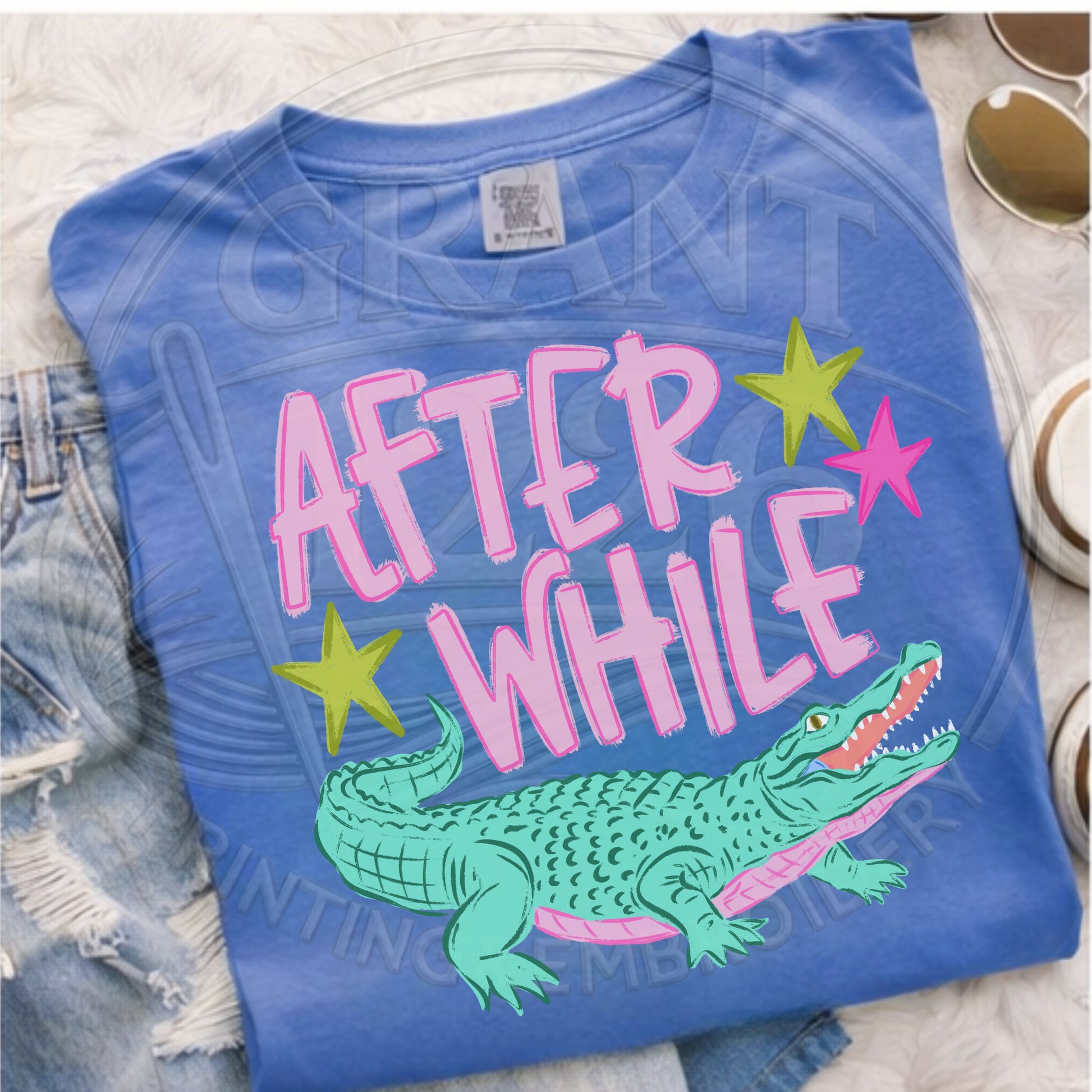 After While crocodile graphic tee close up blue shirt pink lettering croc design detail